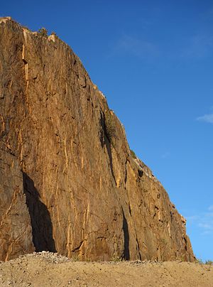 Vertical granite cliff at sunset